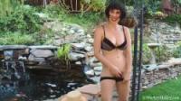 Short-haired woman showing her fluffy pussy outdoors